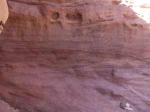 The red sandstone that the canyon is made of. The red color comes from the iron in it. The sandstone is weaker than the limestone and the Basalt around this is why it the erosion made a canyon in it.