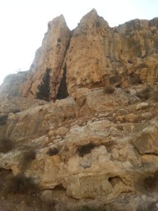 11162013-10 The caves of the monks of the monastery, and the wall of the monastery below. Wadi Qelt