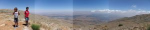 Panorama view east from the top of the Hermon mountain to Syria. See the border?... No? because it is only a virtual line down at the middle of the slope. - family trip