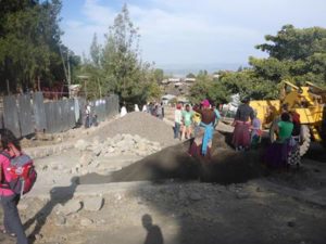 Working in the streets of Lalibela, paving them with stones and casting concrete trenches