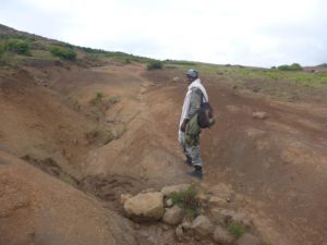 the scout, the Scoria slopes and a small waterfall. - Semien Mountains