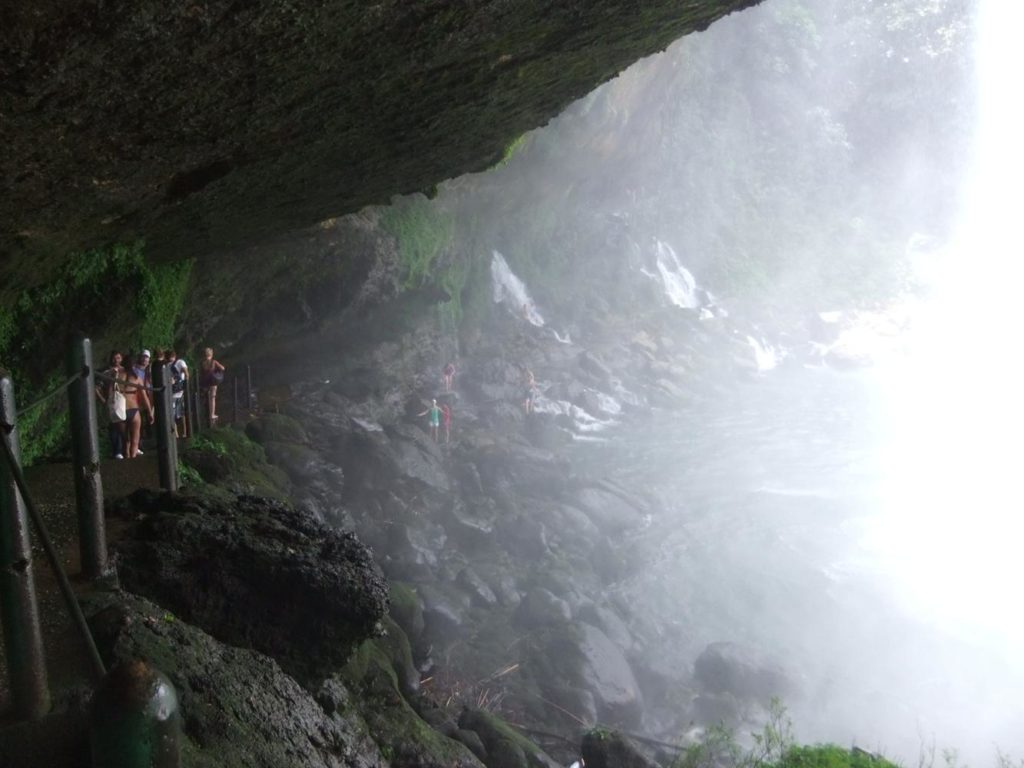 On the secret walk behind the Misol-Ha Waterfall