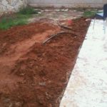 The drain pipe from the other side of the yard.