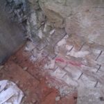 Reinforcement bars inserted into the rock to hold it and connect the rock and the concrete. - drain pipe