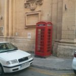 A red telephone booth in the street of Valletta