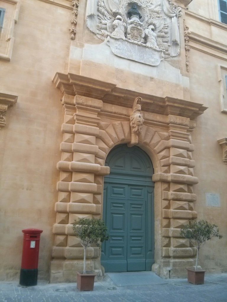 A red mailbox in the street of Valletta