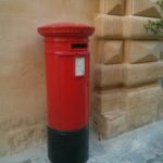 A red mailbox in the street of Valletta