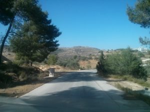 The road outside Dolev, you can see the "Officers' residents", unfinished building from the time Yasser Arafat was the PA president