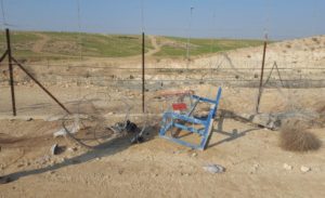 The opening in the fence this afternoon - opened with a supermarket cart and a school table. Illegal workers