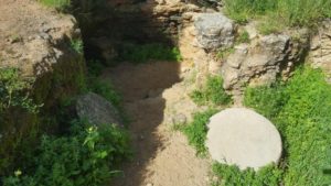 Third cave with the round rock that used to sill the cemetery and prevent ritual impurity (Tumah) from the living. - Pi-Glilot
