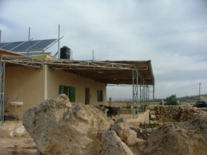 Comet-ME center building. An ecological building - Made of mud and straw, gather water on the roof tank and in the cistern, and produce electricity by using solar panels on the roof. Very soon it will also have a wind turbine on its side.
