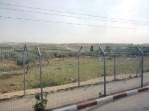 In the distance you can see the fence and road stretched along the hillsTel Gibeon