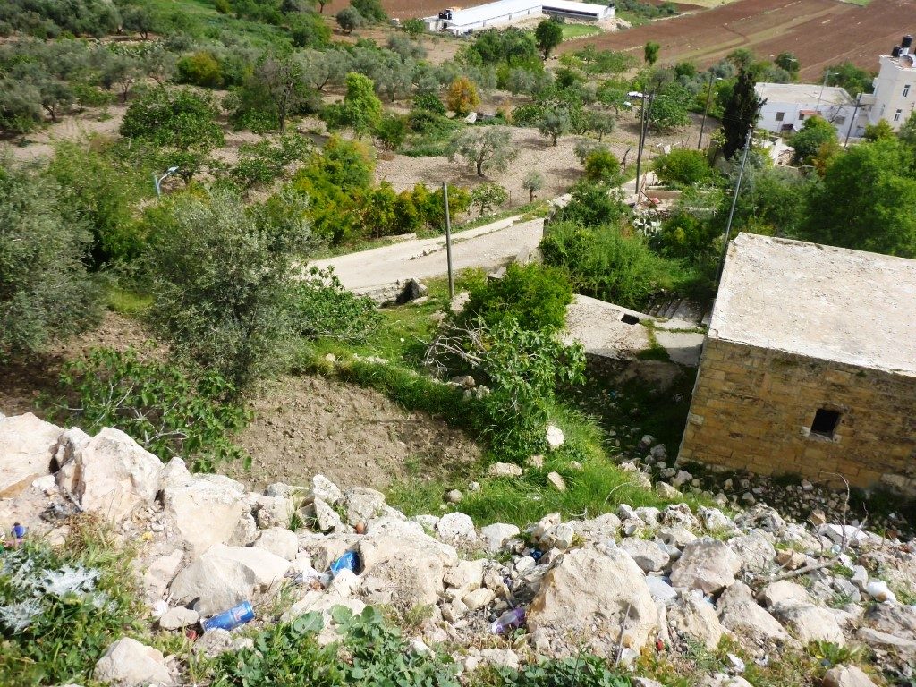 Looking down on the lower entrance and the external tunnel from the edge of top of the tell. The opening in the right pic is a air hole of the external tunnel. - Tel Gibeon