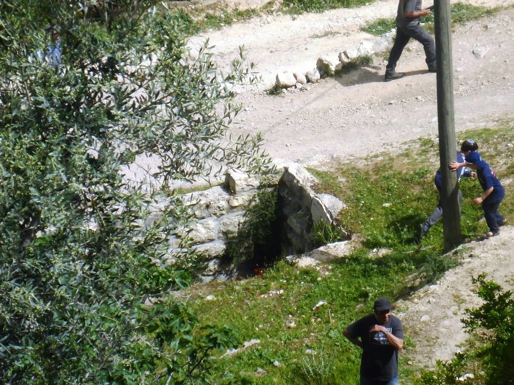 Looking down on the lower entrance and the external tunnel from the edge of top of the tell. The opening in the right pic is a air hole of the external tunnel. - Tel Gibeon