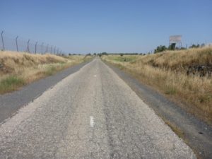 A sign on the side of the road saying: "People have died here before you. Don't hurry". Petroleum road