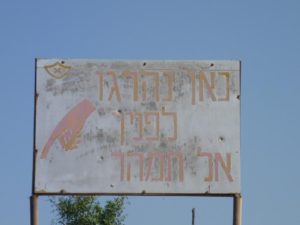 A sign on the side of the road saying: "People have died here before you. Don't hurry". Petroleum road