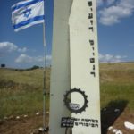 A memorial. In the bottom of each signs it is says Yom Kippur war. The small signs says "Renovated by Golan heights winery 26.04.2015". The vertical writing are the name of the dead: Eliezer Lightner, Moshe Avnaim, Aharon Aharoni.