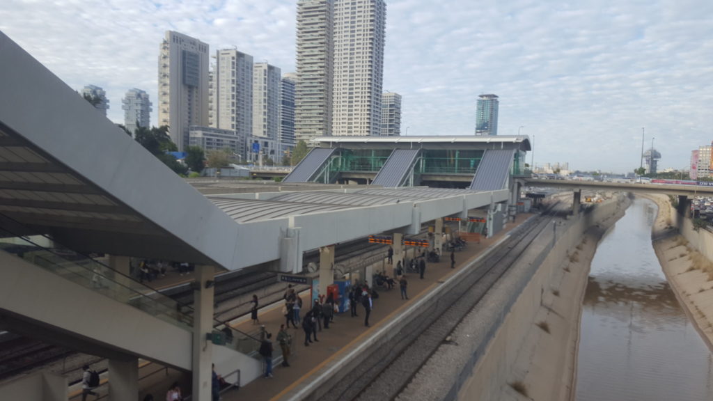 Ayalon transportation corridor: The Highway, the railway in the stream low in the concrete trench. Day and night from both sides of Tel-Aviv center train station.