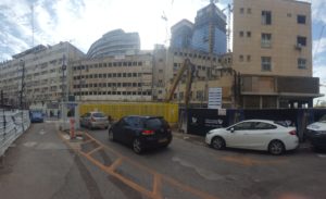 The Back of Beit Ma'ariv. The Excavator is waiting to start the work. - Beit Ma'ariv demolition