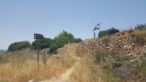 A sign and the flag over the memorial