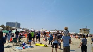 Tel Aviv beach full of people looking at the sky - Independence day air show