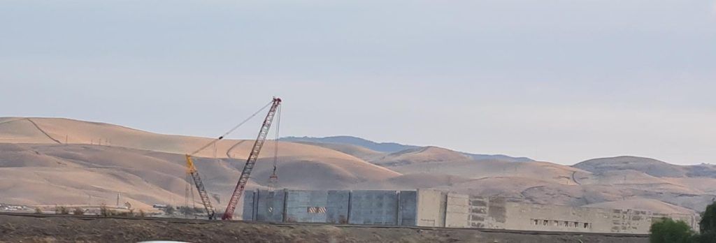 A method of construction I was not familiar with, till the friend in Florida told me about - you cast the concrete walls on the ground around the building and lift it up. The inner space will be covered by light steel roof on steel columns. - American construction