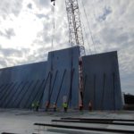A method of construction I was not familiar with, till the friend in Florida told me about - you cast the concrete walls on the ground around the building and lift it up. The inner space will be covered by light steel roof on steel columns. - American construction