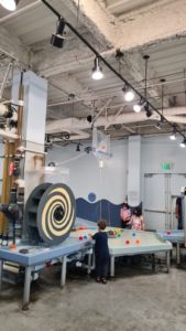 Concrete cast on steel deck on composite steel beams, all covered with fireproofing material (sounds like a nice dish for dinner, isn't it? 😉) in Children Museum in San Jose In Israel we don't use the cement material, just paint it.