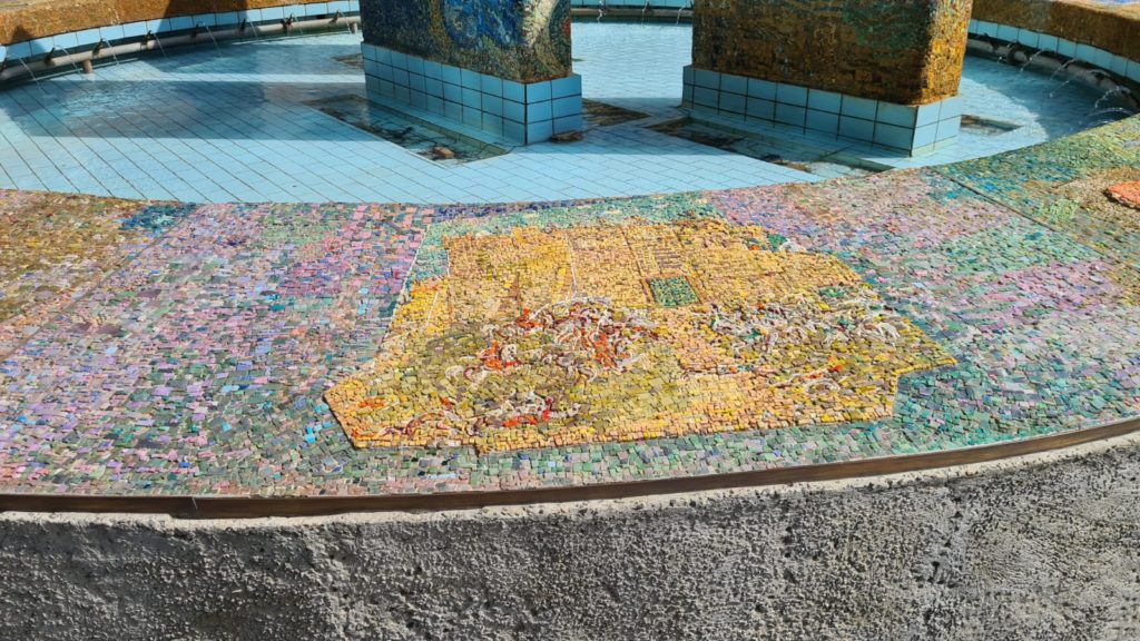 The scenes on the mosaic on the curve around the fountain