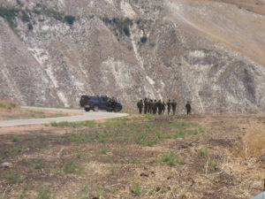 IDF soldiers standing on the edge, just above the border triangle