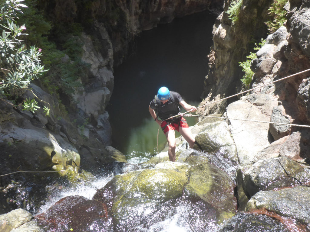 Rappelling down the third waterfall - 20m high with positive slope. On the bottom there is a 50m long pool