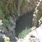 Rappelling down the third waterfall - 20m high with positive slope. On the bottom there is a 50m long pool