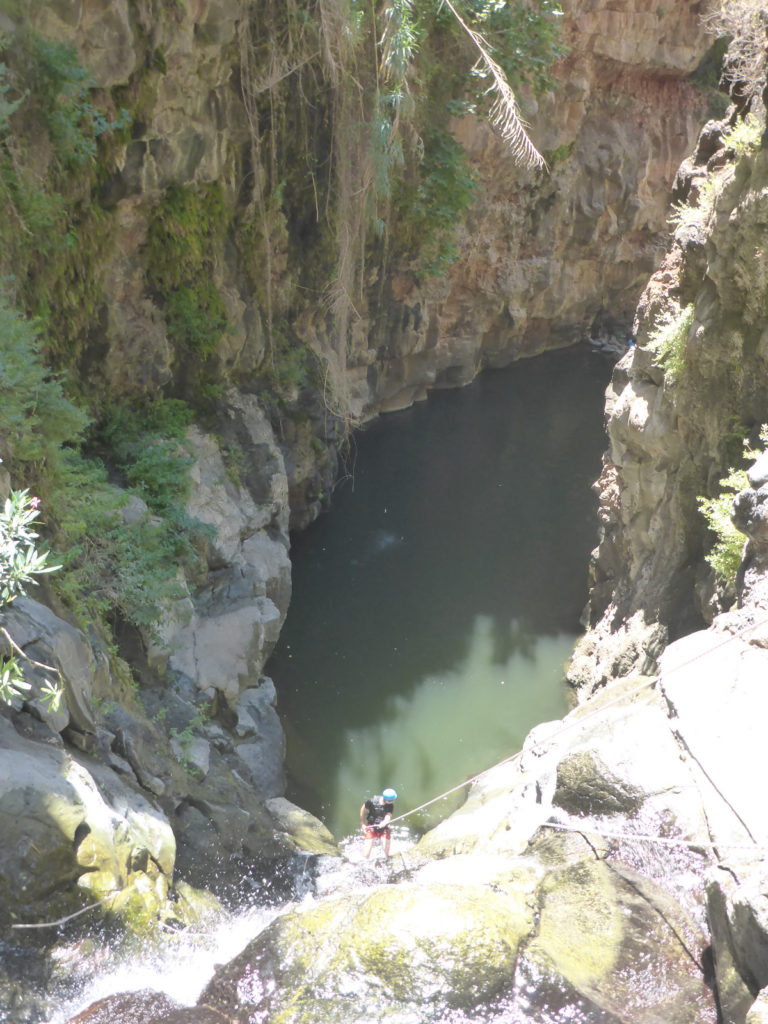 Rappelling down the third waterfall - 20m high with positive slope. On the bottom there is a 50m long pool