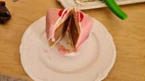Look on those layers of sponge cake, nougat and biscuit covered with sweet pink cover and an alcoholic cherry on top - Punschkrapfen