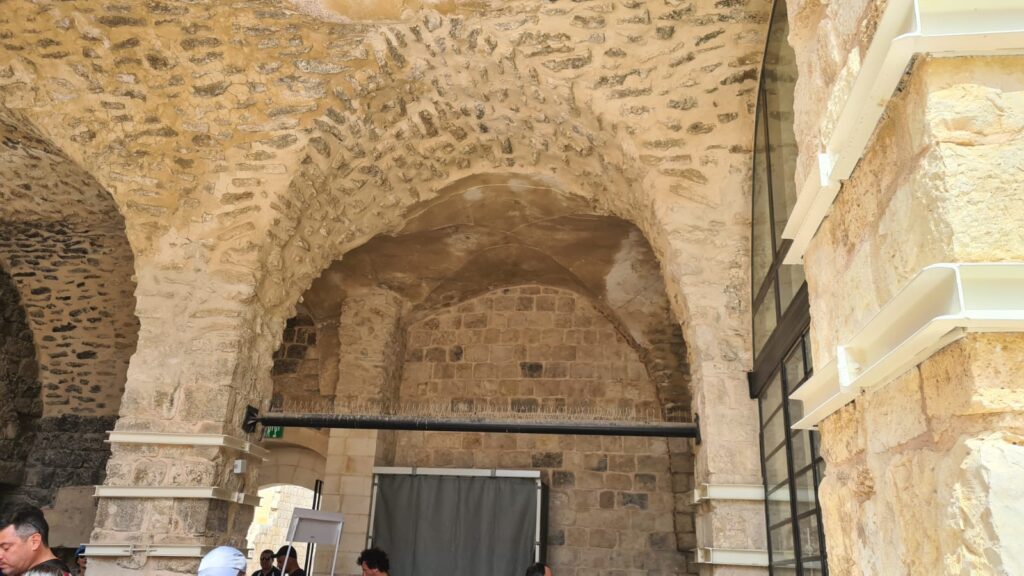 Retrofitting the castle: holding the bottom of the arches (by adding an element that can stand tension on the bottom of the arches) and holding the columns by adding confining steel hoops to hold the columns.