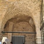 Retrofitting the castle: holding the bottom of the arches (by adding an element that can stand tension on the bottom of the arches) and holding the columns by adding confining steel hoops to hold the columns.