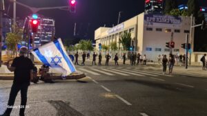 A row of policeman about to clear the junction