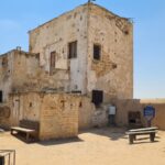 The security house which was built by the demand of the British authorities. As some of the people were policeman and had to carry weapon, it had to be kept in a secure place and not in a building made of mud.