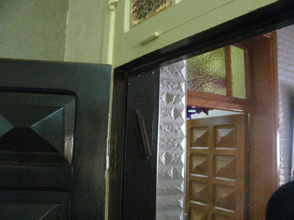 The entrance to the house of the samartian that housed us: a sign in Hebrew and a Mezuzah