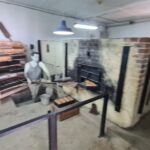 The bakery produced bread for the Kibbutz and Rehovot. The 10 ton oven had rails and covered a bigger access open to the factory which was only used 3 times: to get the machinery in, to once upgrade it and to pull the machinery out. The chimeny used to hid the  pollution from the factory.