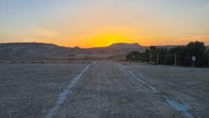 Sunrise at the desert, while the booms of war are in the background 