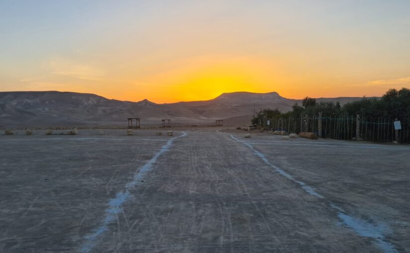 Sunrise at the desert, while the booms are in the background