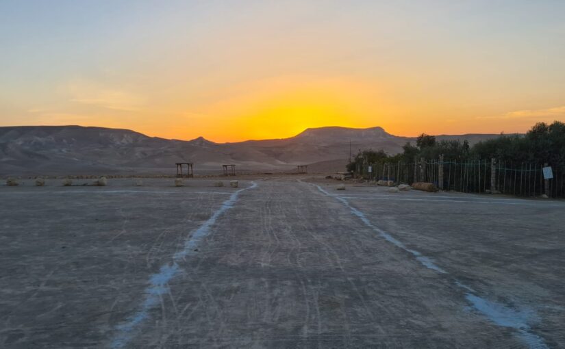 Sunrise at the desert, while the booms are in the background