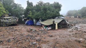 Our camp of APCs and tents is covered with canvas and shed sheets agter the rain