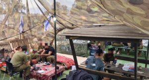 The company soldiers are sitting down smoking and talking, passing the time - Sabbath in the army 