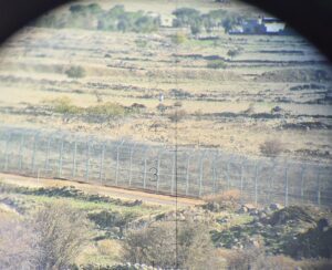 The Israeli-Syrian border: the fence and the line of barrels that mark the line that can not be crossed by Syrian civilians (they are looking for Tuber)