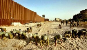 Mandatory duty soldiers Crawling on Philadelphi Route along the Egyptian border with Gaza strip, looking for pieces of bodies from the Nagmash disaster. (Source: Barkay wolfoson/AP, Haaretz.com)