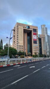 Bring the home now, sign on a building on Ramat Gan Diamond Exchange district. The hostage picture on it is of Omri Meiran, 46 years old from Kibbutz Nahal Oz.