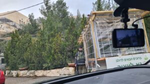 The guarding soldier on the gate at the entrance to Dolev - driving to Dolev