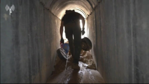 A soldier carrying landmines into a tunnel in order to demolish it - Underground maneuver 